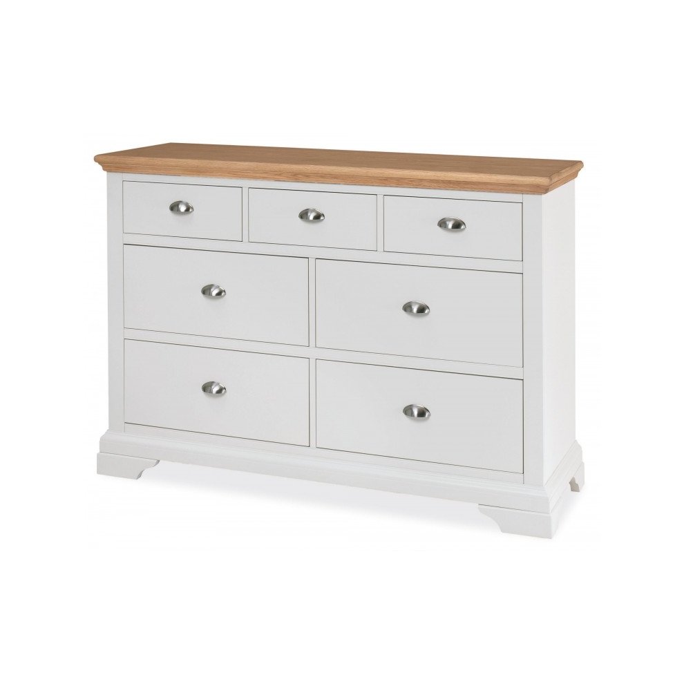 Cream-colored wooden chest with a natural oak top, featuring three small drawers and four larger drawers, all with silver knob handles and a classic design.