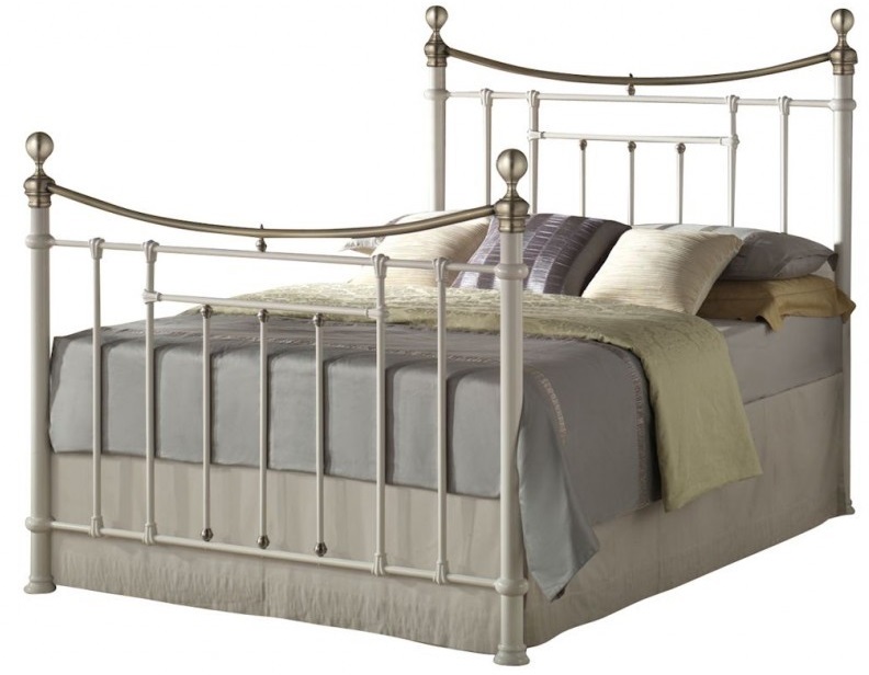 Cream-colored Birlea Bronte double bed featuring a metal frame with decorative finials and curved headboard, complemented by plush bedding in neutral tones.