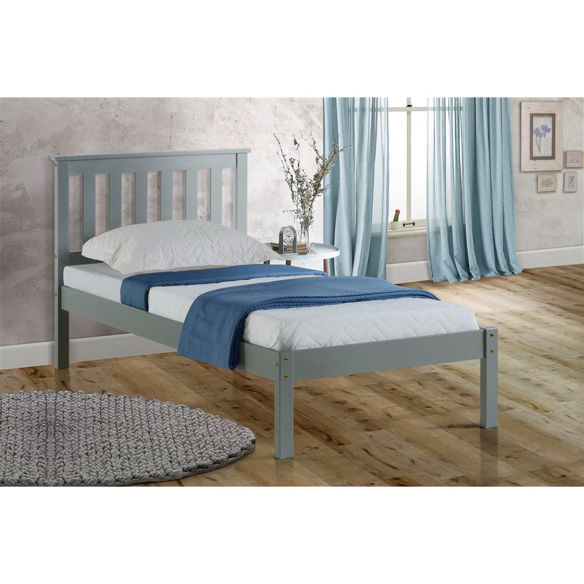 Single Birlea Denver bed in grey, featuring a slatted headboard, sturdy wooden frame, and a minimalist design, styled with a white mattress and blue throw blanket in a bright room.