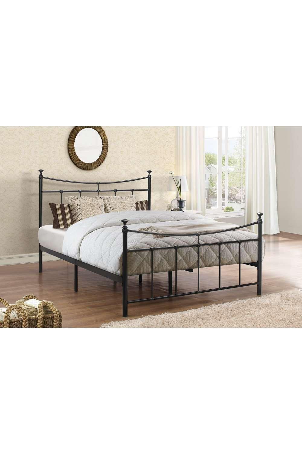 Double Birlea Emily bed in black metal with a classic design, featuring decorative finials, a sturdy frame, and a cozy mattress topped with a light quilt in a bright room setting.