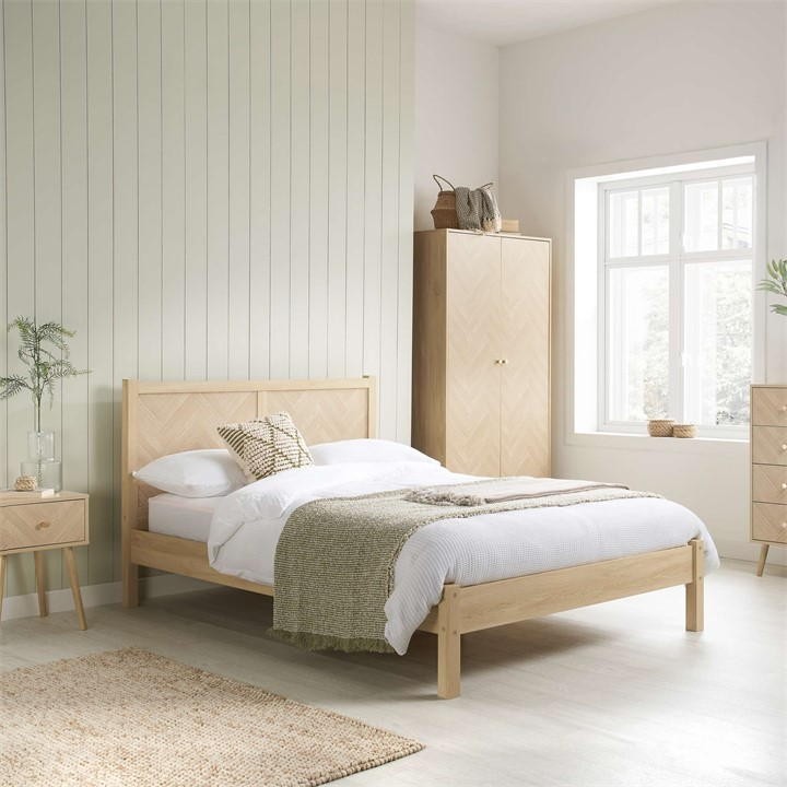 Birlea double bed frame in light oak features a herringbone design, sturdy wooden construction, and a minimalist style, set in a bright, modern bedroom with natural decor.