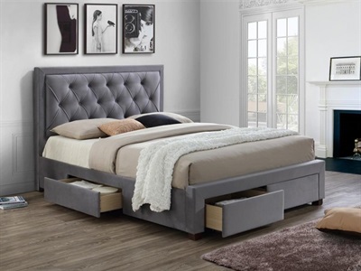 Grey upholstered double bed with a tufted headboard, featuring two storage drawers at the base, set in a bright room with large windows and modern decor.