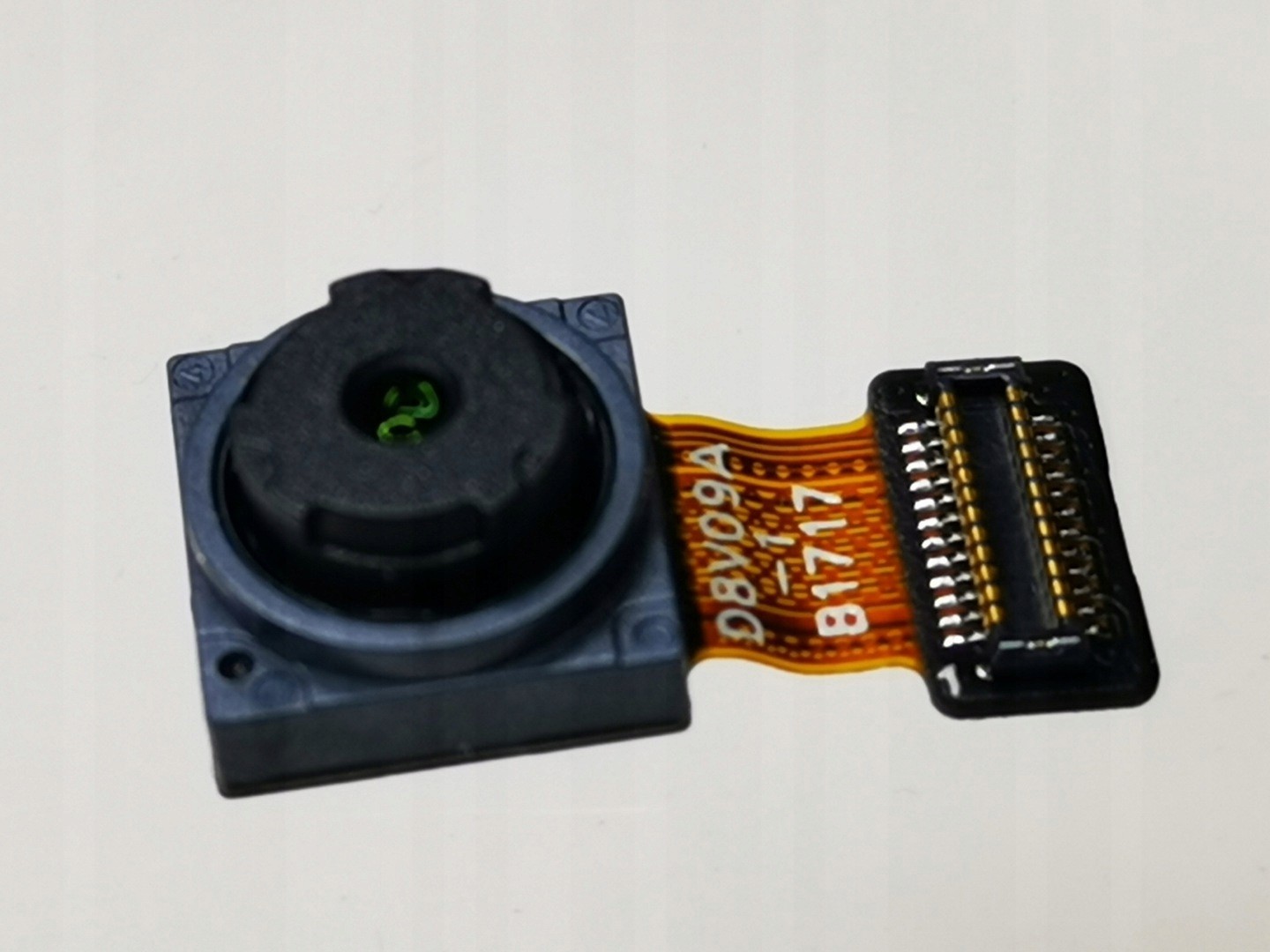 Front camera module for Honor 8 Pro, featuring a black lens housing, green lens, and a flexible ribbon connector with gold contacts.