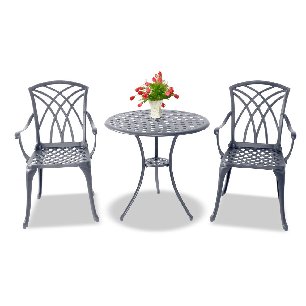 Luxurious grey cast aluminium bistro set featuring a round table and two large chairs with armrests, showcasing an intricate lattice design and accompanied by a vase of red tulips.