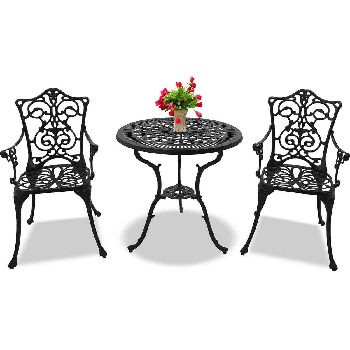 Black cast aluminum bistro set featuring a round table with intricate cut-out design and two large chairs with armrests, complemented by a vase of flowers on the table.
