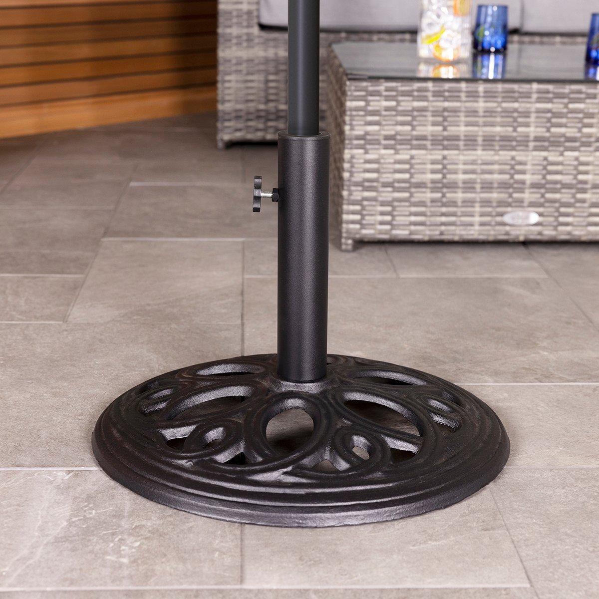 Black cast iron patio umbrella base stand with an ornate circular design, featuring a central pole holder and a tightening knob for stability.