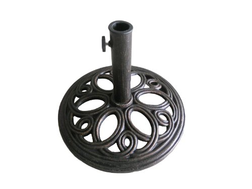 Round, ornate cast iron umbrella base in dark bronze finish, featuring intricate circular patterns and a central pole holder with a securing screw.