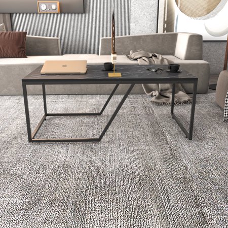 Wendy Metal Leg Coffee Table in Bendire Black features a sleek black metal frame, a minimalist design, and a rectangular top, set on a textured gray rug with modern sofas in the background.