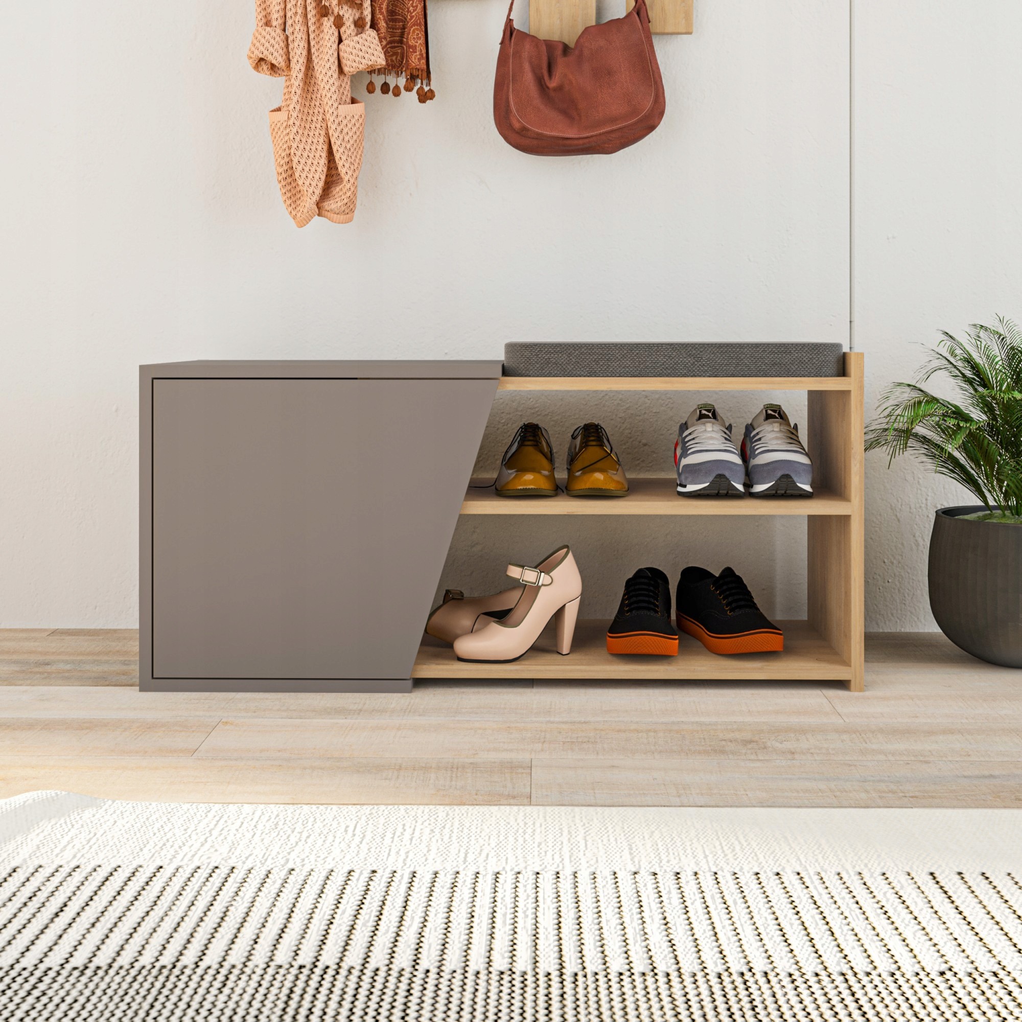 Stylish shoe storage unit in mocha and gray, featuring a sleek design with a closed compartment and open shelves, showcasing various shoes and a decorative plant nearby.