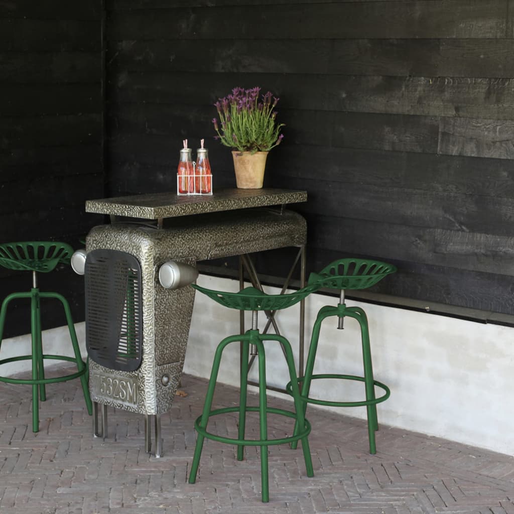Green Esschert Design Bar Tractor Chair features a metal frame with a tractor-inspired design, complemented by a matching green seat and backrest, set against a dark wooden wall.