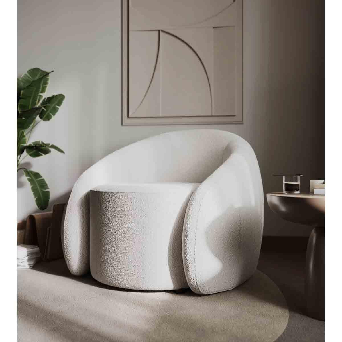 Cream boucle teddy accent swivel chair with rounded arms and a plush, textured finish, set in a minimalist interior with a plant and abstract artwork.