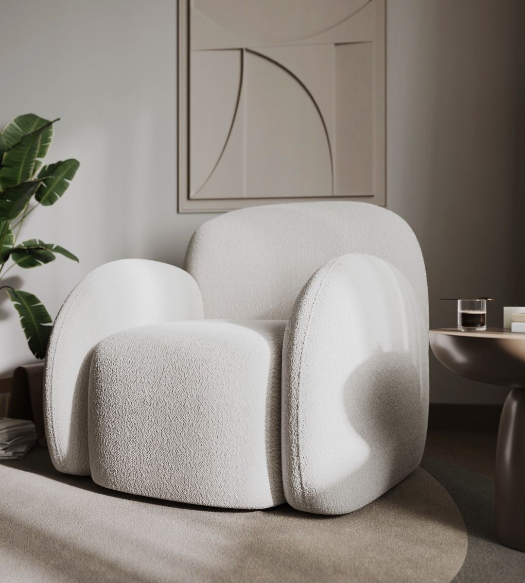 Cream boucle teddy accent chair with rounded arms and a plush, textured finish, set against a minimalist backdrop with a plant and a side table.