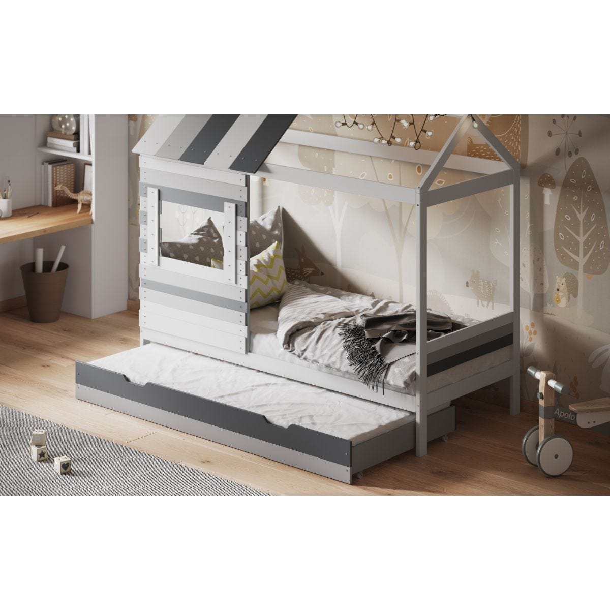 Grey wooden house bed with a trundle, featuring a slanted roof design, a window cutout, and a cozy mattress, set against a softly decorated room with wooden flooring.