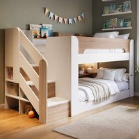 White and oak low bunk bed with staircase, storage shelves, and cozy bedding, ideal for children's room.