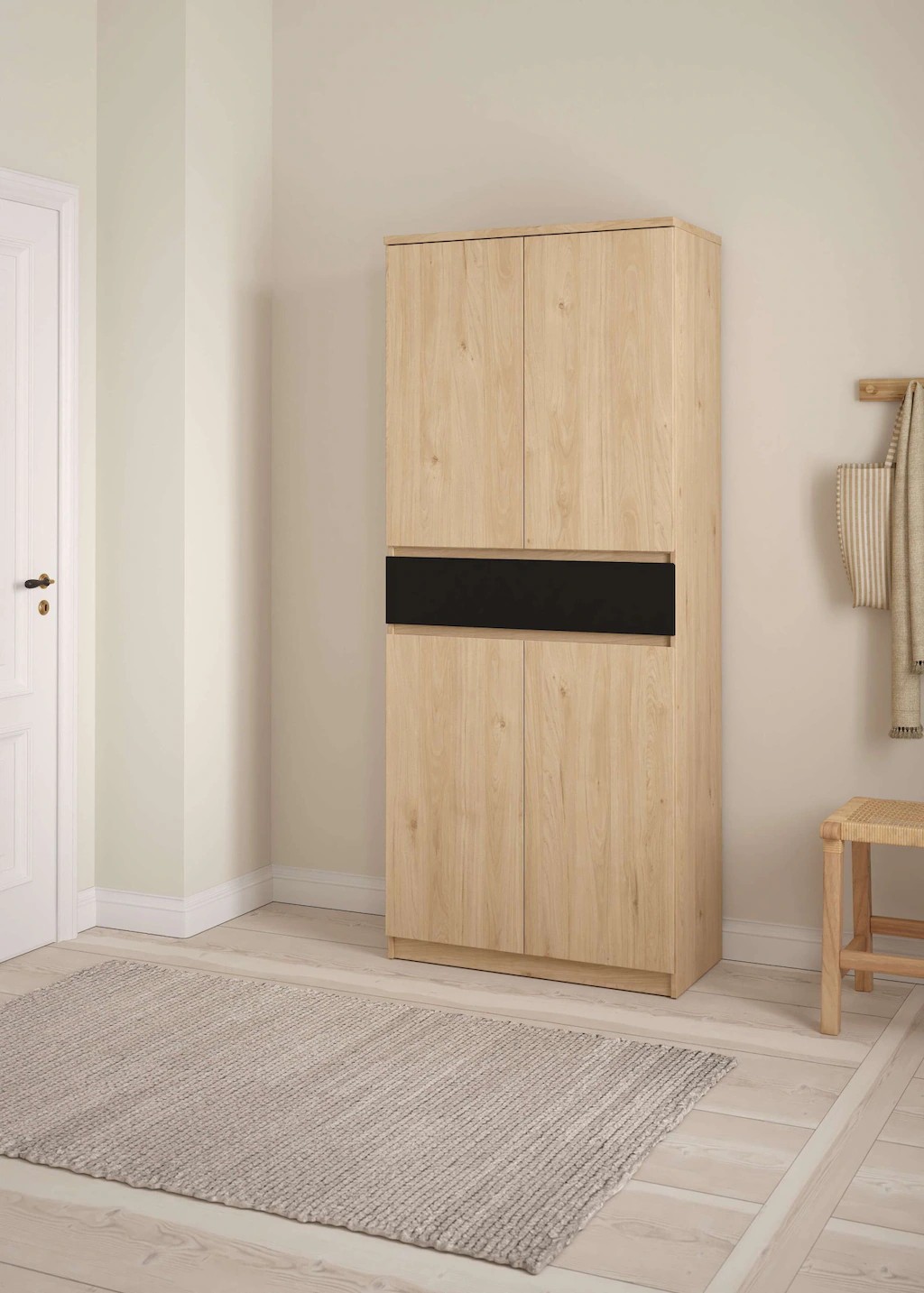 Naia Shoe Cabinet features a light wood finish with a sleek black panel, four doors, and one drawer, perfect for organizing footwear in a modern indoor space.