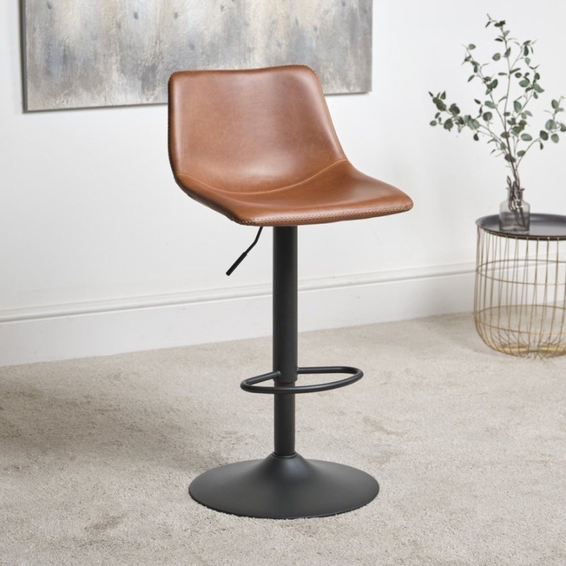 Height adjustable bar stool with a brown faux leather seat, black metal base, and footrest, set against a neutral background with decorative plant and wall art.