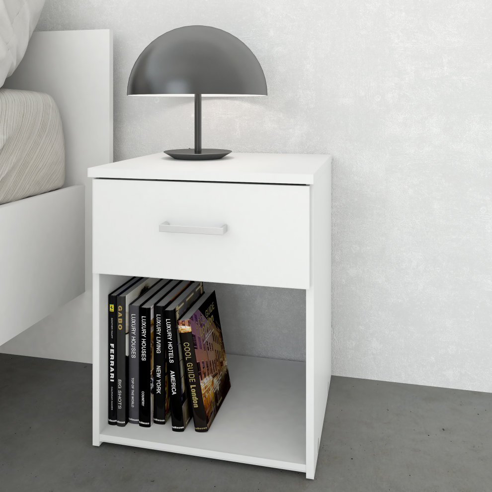 White bedside table with one drawer and an open shelf, featuring a sleek design, accompanied by a modern black lamp and neatly arranged books below.