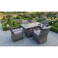 Four Seater Rattan Outdoor Garden Fire Pit Dining Set with gray cushions and glass-top table in a lush garden setting.