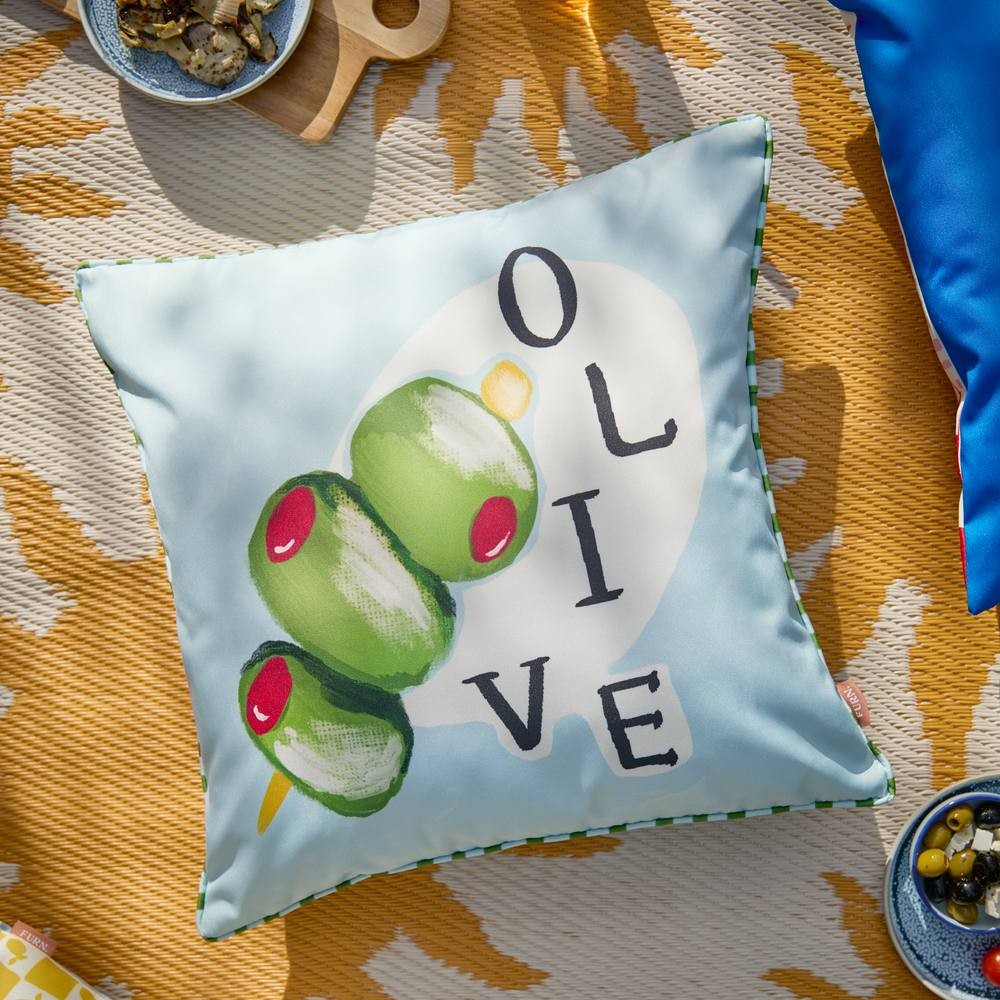 Square outdoor cushion featuring a light blue background with a vibrant olive graphic and the word "OLIVE" in bold black letters, edged with a green trim.