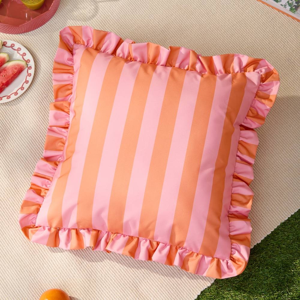 Orange and pink striped outdoor cushion with a ruffled edge, featuring a soft fabric suitable for outdoor use, ideal for adding a pop of color to any patio or garden setting.