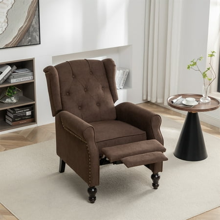 Brown velvet wingback recliner chair with diamond tufting, wooden legs, and a push-back footrest, set in a modern living room with a side table and decor.