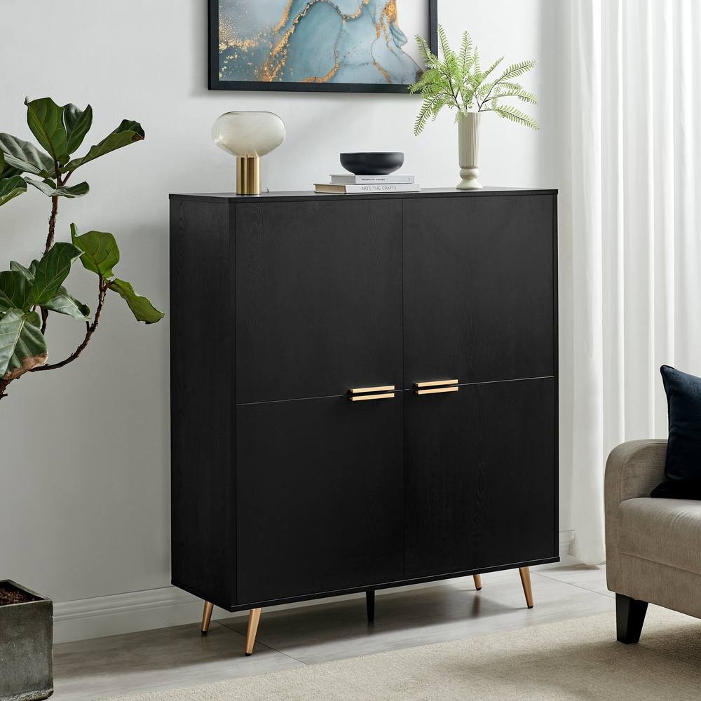 Medium-sized sideboard in black wood with copper effect handles, featuring two doors, sleek design, and standing on tapered legs, complemented by decorative items and greenery.