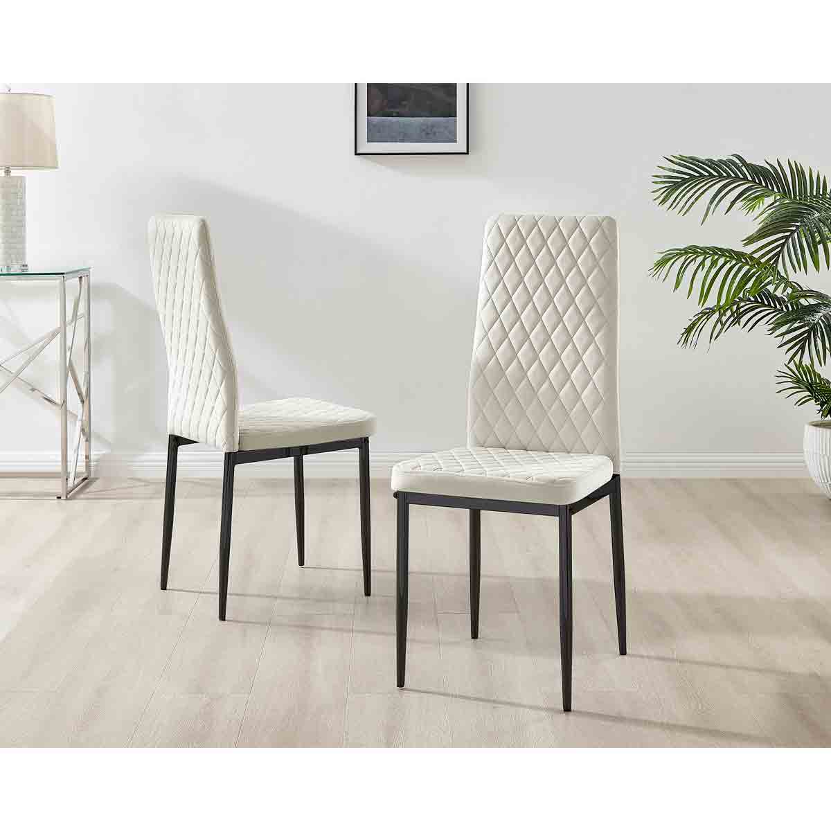 Cream velvet dining chairs with diamond quilted pattern and sleek black legs, set against a light wooden floor and minimalistic decor.