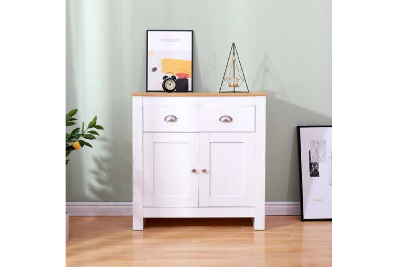 White sideboard featuring a natural wood top, two doors, and three drawers, complemented by decorative items like a clock and framed art against a soft green backdrop.