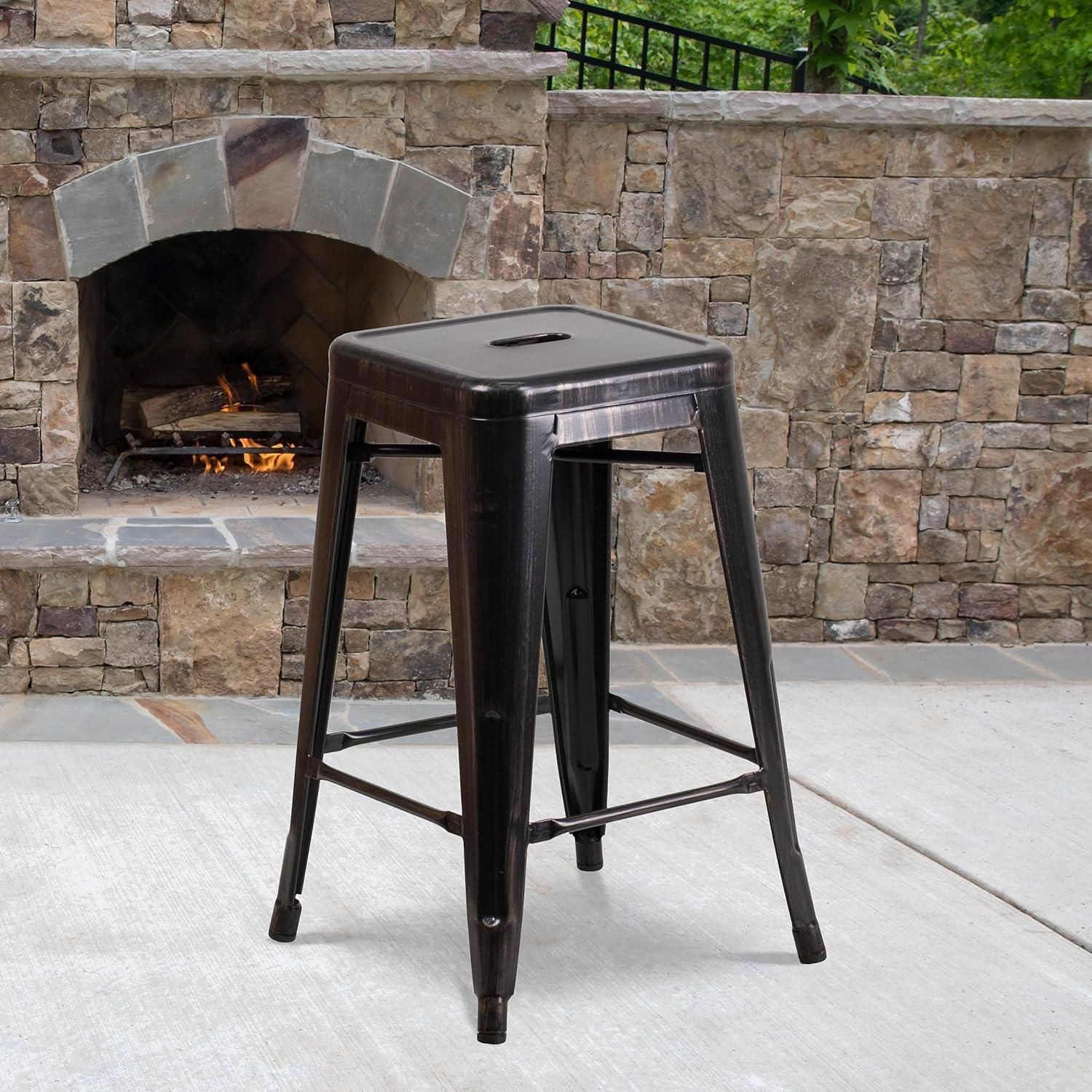 Set of 4 black and gold bar stools made from galvanized steel, featuring a square seat with a cutout and sturdy legs, suitable for indoor and outdoor use.