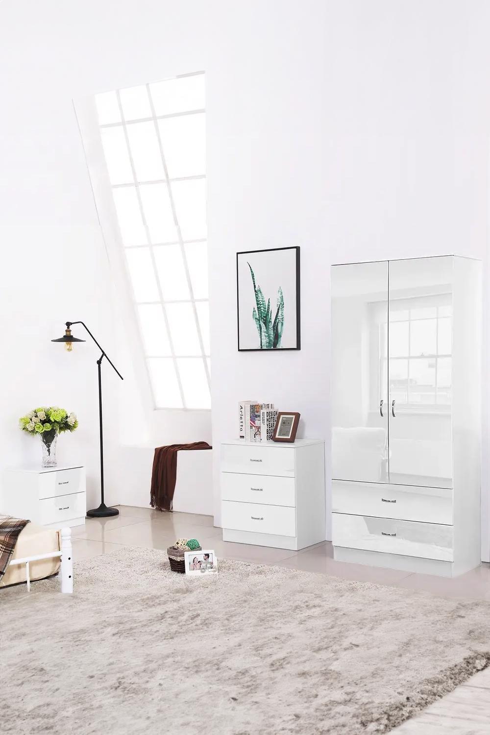 High gloss black wardrobe featuring two doors and two drawers, sleek design with a modern finish, complemented by a stylish interior setting with a lamp and decorative items.