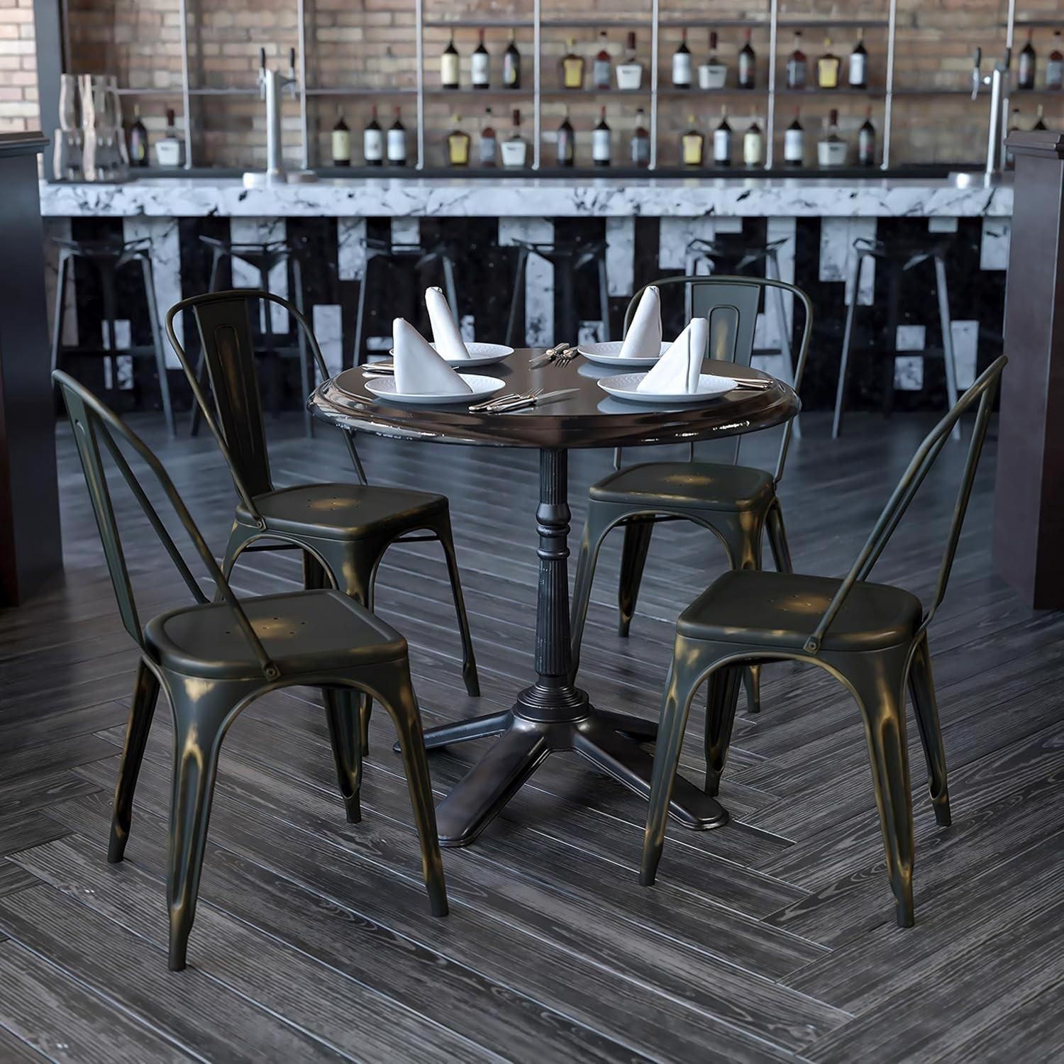 Set of four brown copper galvanised steel chairs with a sleek design, arranged around a round black table in a stylish indoor setting.