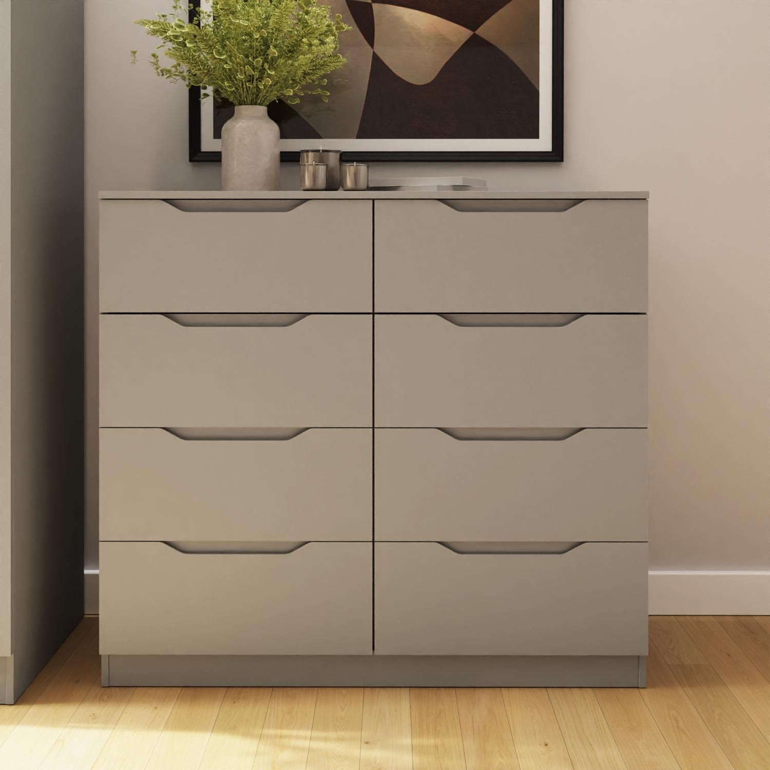 Modern wide chest of drawers in beige with eight spacious drawers, featuring sleek handles and a minimalist design, complemented by a decorative vase and artwork above.