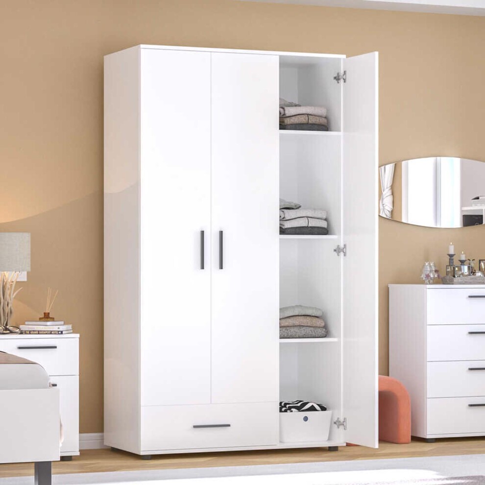Matt white large wardrobe with three doors and one drawer, featuring sleek black handles, interior shelves, and a minimalist design, set against a neutral wall.