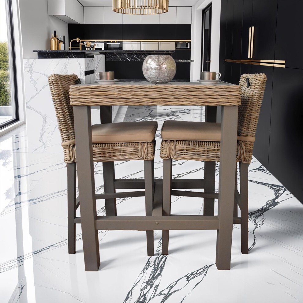 Grey wash bar table with a painted finish, made of solid reclaimed pine, featuring a textured top and sturdy legs, paired with two woven wicker stools.