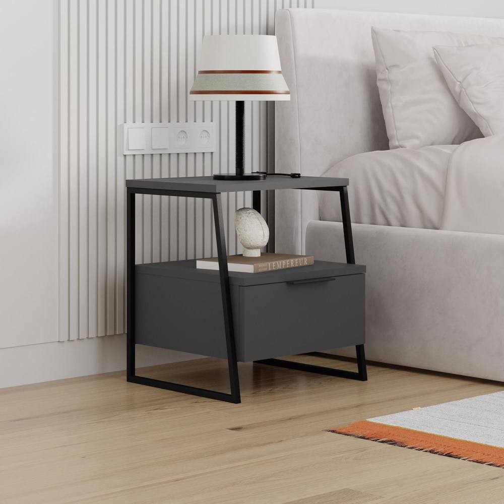 Anthracite grey bedside chest table with a single drawer and open shelf, featuring a modern black metal frame, topped with a lamp and decorative object.