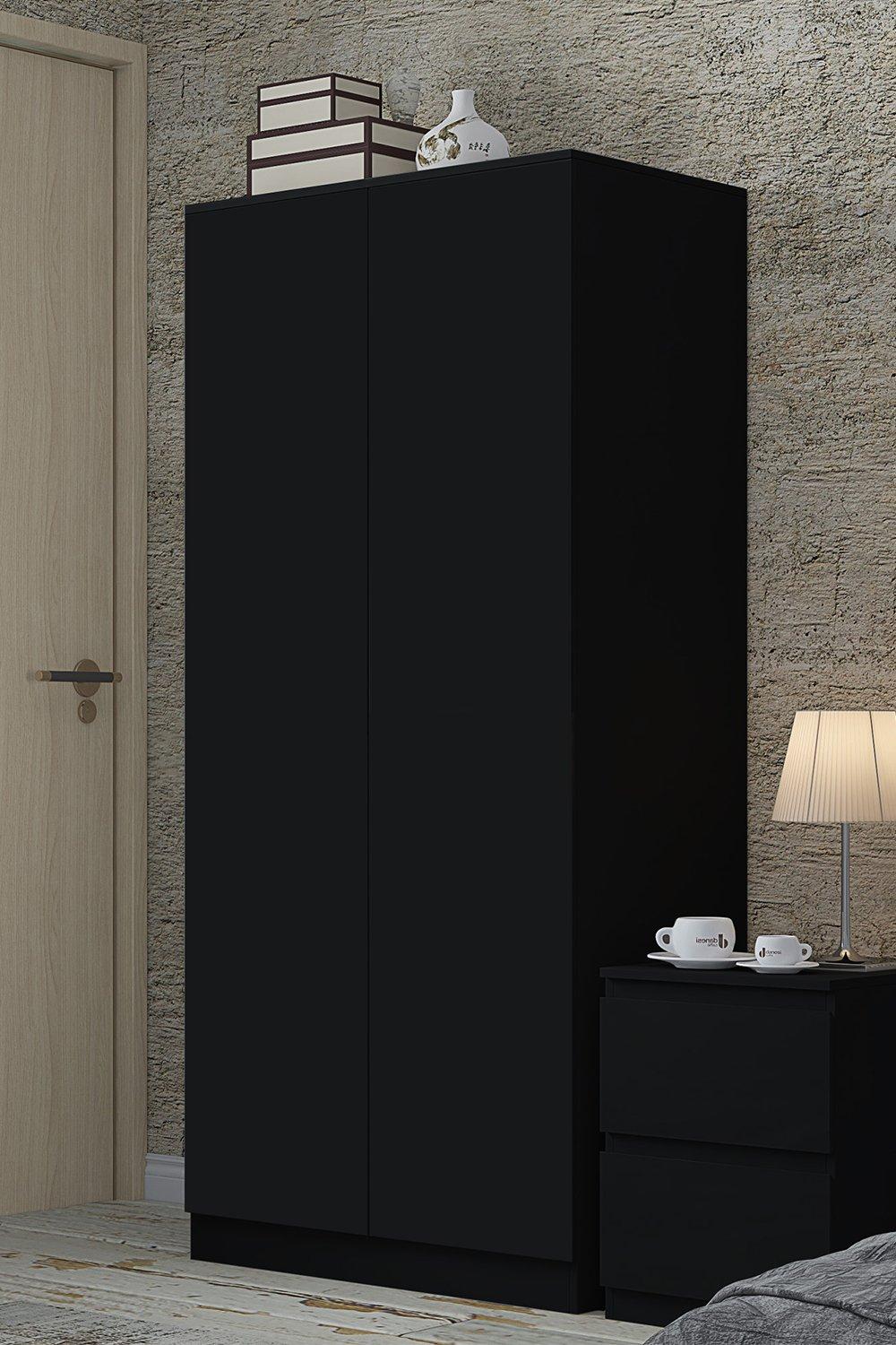 Large wardrobe in matte black finish featuring two doors, sleek design, and minimalist aesthetic, complemented by a nearby nightstand and lamp.