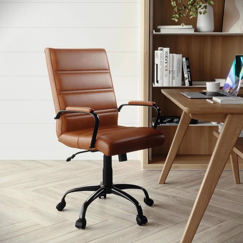 Tan brown faux leather office chair with lumbar support, sleek design, padded seat and back, adjustable height, and black rolling base, positioned near a wooden desk and bookshelves.
