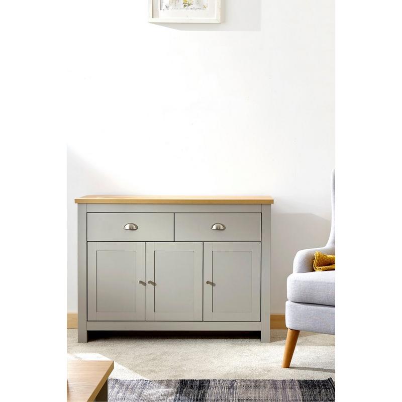 Large grey sideboard with a natural wood top, featuring two drawers and three cabinet doors, set against a light wall, complemented by a grey armchair nearby.