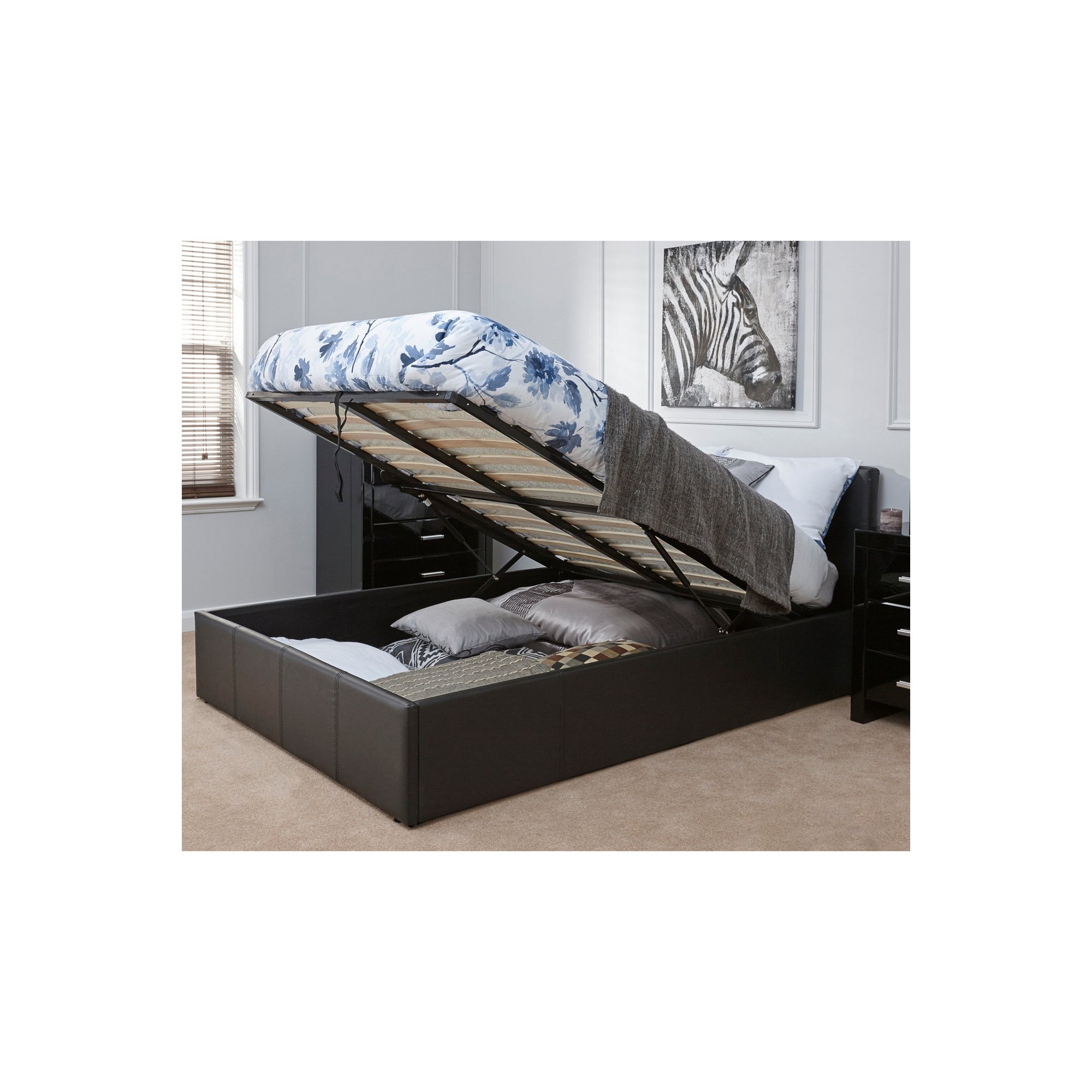 Grey PU bed frame with a lift-up mechanism, featuring a Bonnell mattress and floral-patterned bedding, showcasing ample storage space underneath.