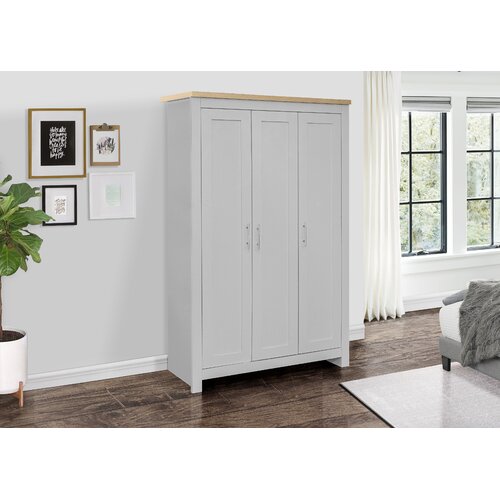 Cream and oak three-door wardrobe with a grey finish, featuring a clean design, sleek handles, and a natural wood top, placed in a well-lit room with large windows.