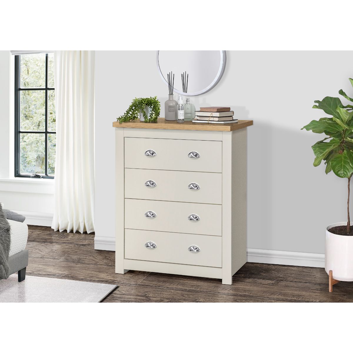 Birlea Highgate 4 Drawer Chest features a cream body with an oak top, four spacious drawers with silver handles, set against a light grey wall and accompanied by decorative items.