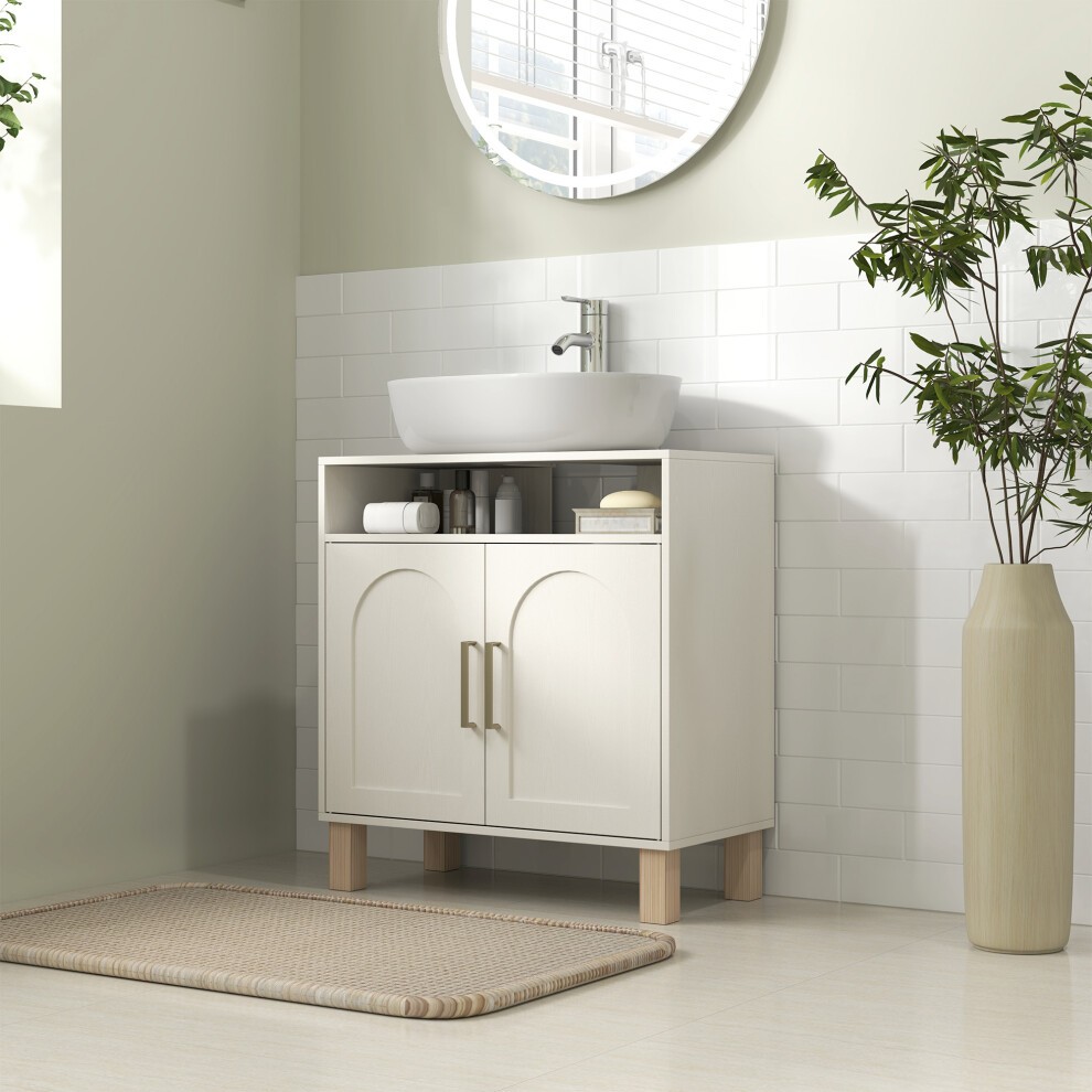 Cream white under sink bathroom cabinet with a smooth finish, featuring two doors, open shelf, wooden legs, and a modern basin on top, set against a light green wall.