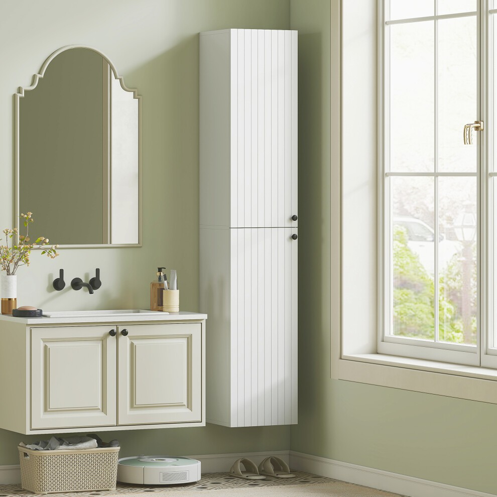 White wall-mounted slim bathroom storage cabinet with six tiers, featuring a sleek design and vertical paneling, positioned beside a mirror and sink in a light green room.