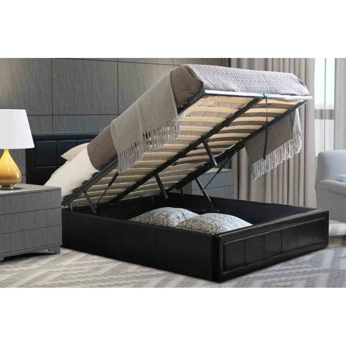 Black leather ottoman bed with a lifting mattress revealing storage space underneath, featuring a modern design and a cozy blanket draped over the top.