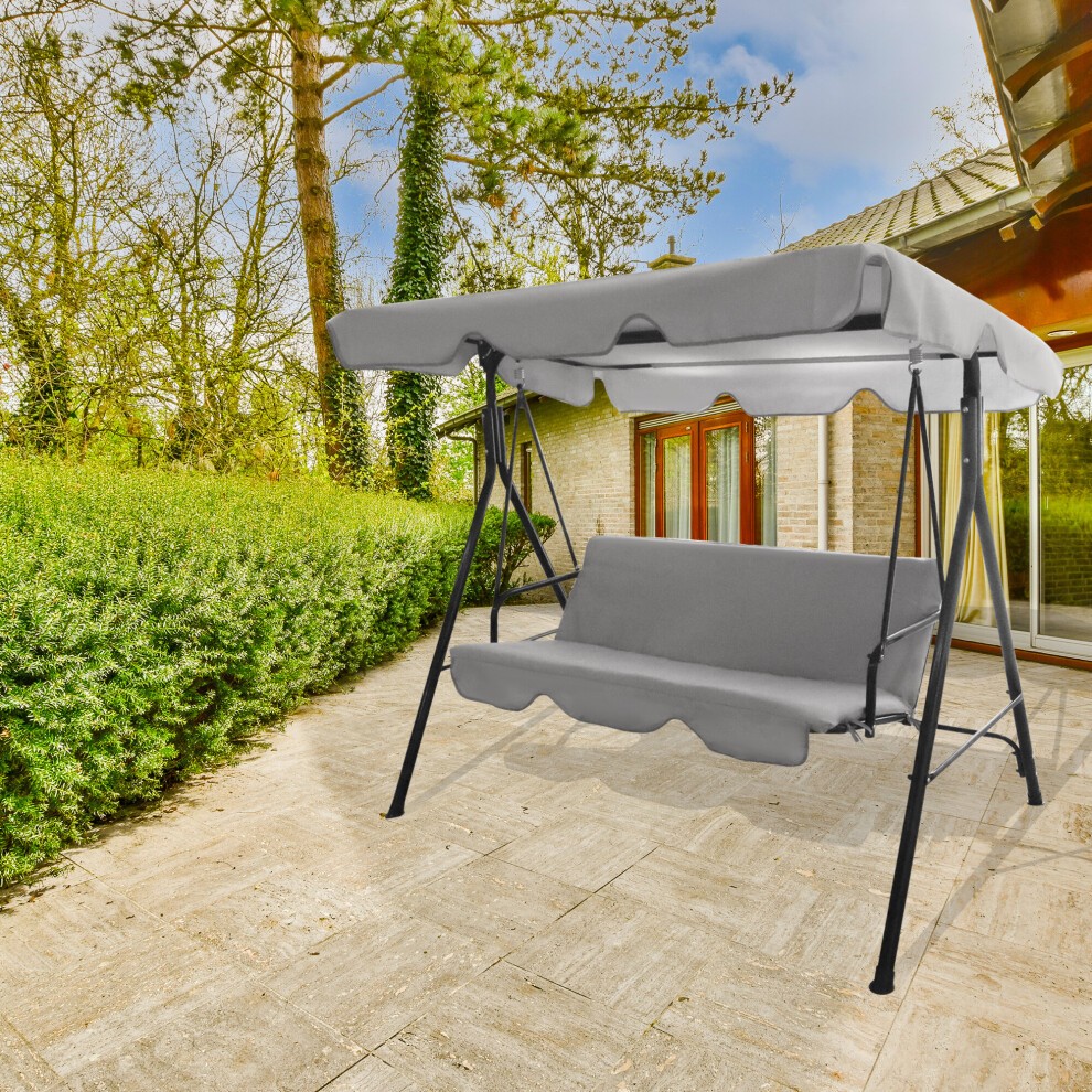 Grey 3-seater garden swing chair with a canopy, featuring a sturdy black frame and cushioned seating, set on a stone patio surrounded by greenery.