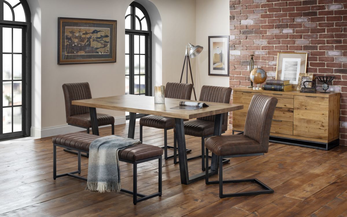 Brown upholstered bench with a sleek black metal frame, featuring a horizontal ribbed design, placed in a modern dining room setting with a wooden table and stylish chairs.
