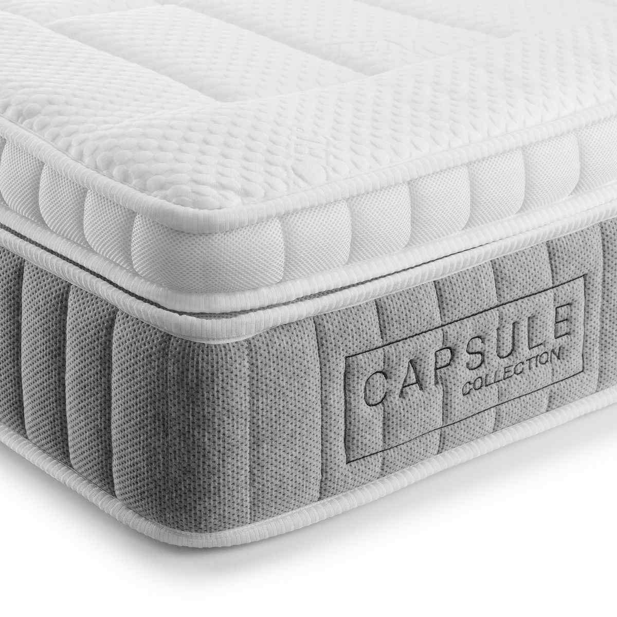 White pocket sprung mattress with a cooling pillow top, featuring a textured grey fabric border and "CAPSULE COLLECTION" branding on the side.