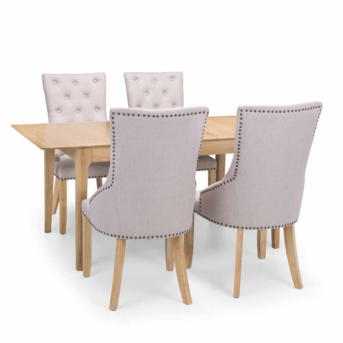 Brown wooden table with a rectangular top and four upholstered Loire dining chairs featuring tufted backs and studded detailing in a light fabric.