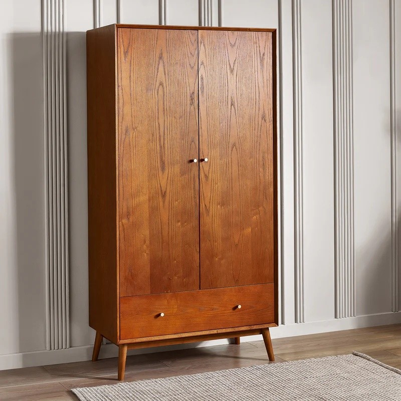 Lowry wardrobe in dark wood featuring two doors, a bottom drawer, and tapered legs, showcasing a sleek, modern design with a natural wood finish.