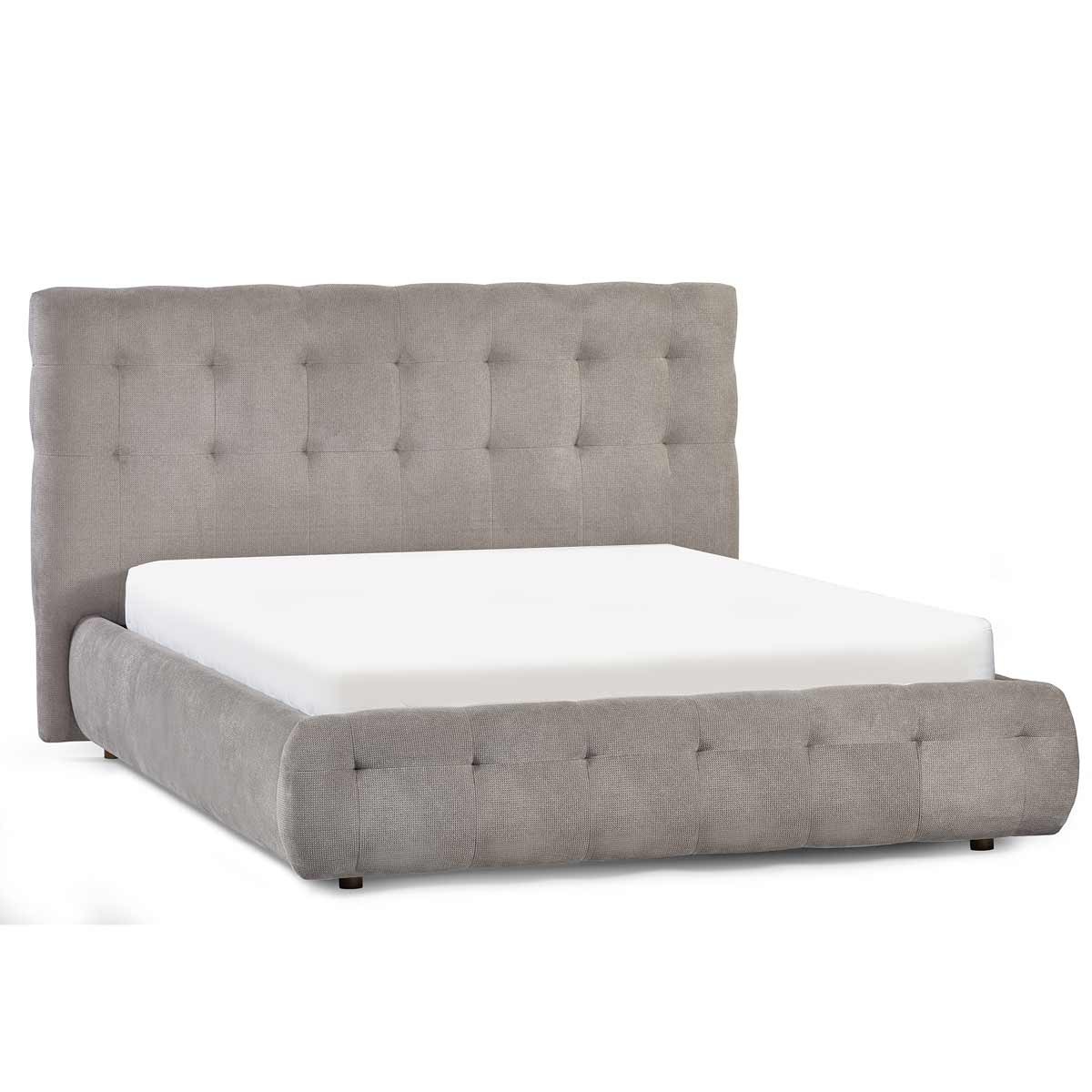 Light taupe upholstered king bed with a tufted headboard and a low-profile base, featuring a sleek design and soft fabric, ideal for modern bedroom decor.